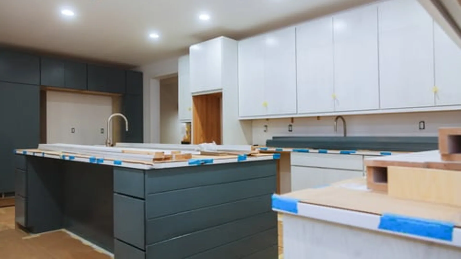 Newly remodeled kitchen with a navy island and custom white cabinetry in a Garland, Texas home